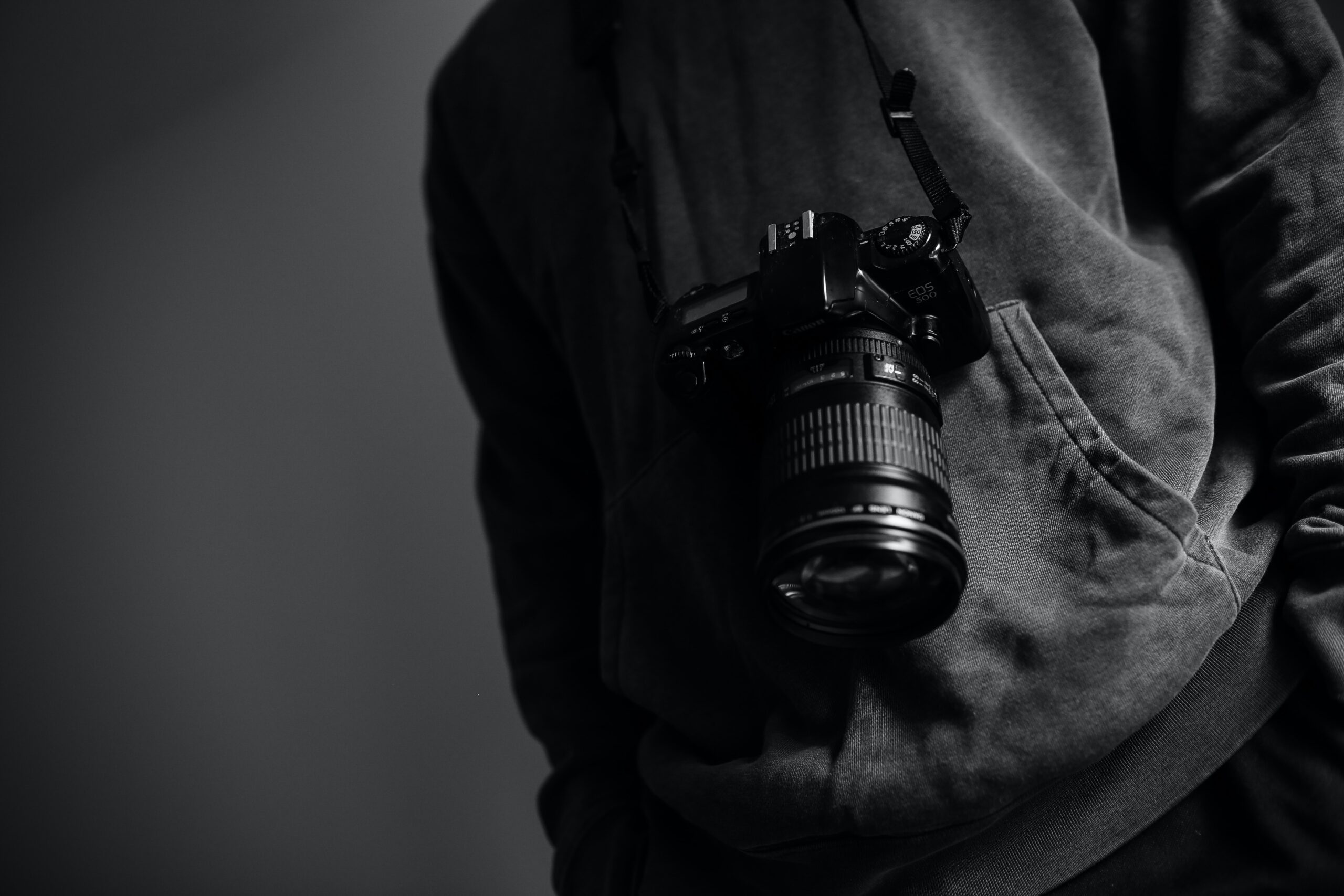 Black and white photo of a person with a camera