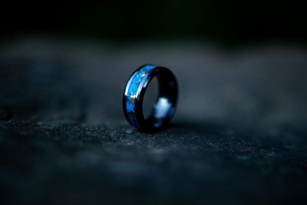 A blue and black ring on a rocky surface