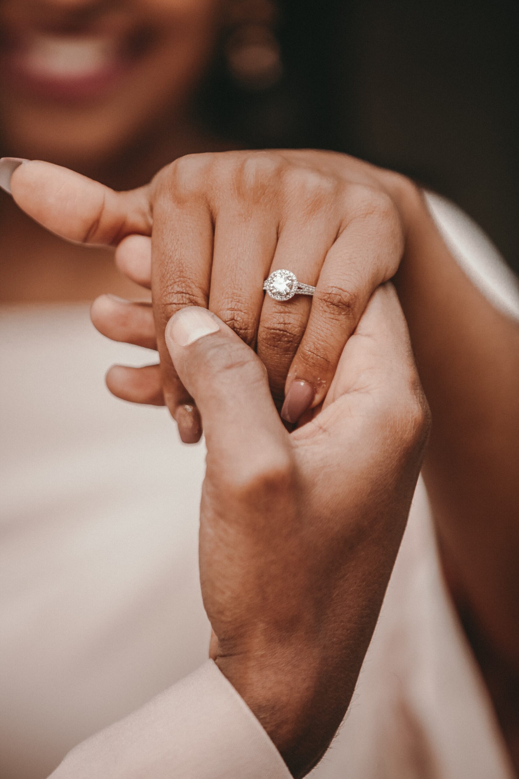 Woman showing her hand with a diamond ring