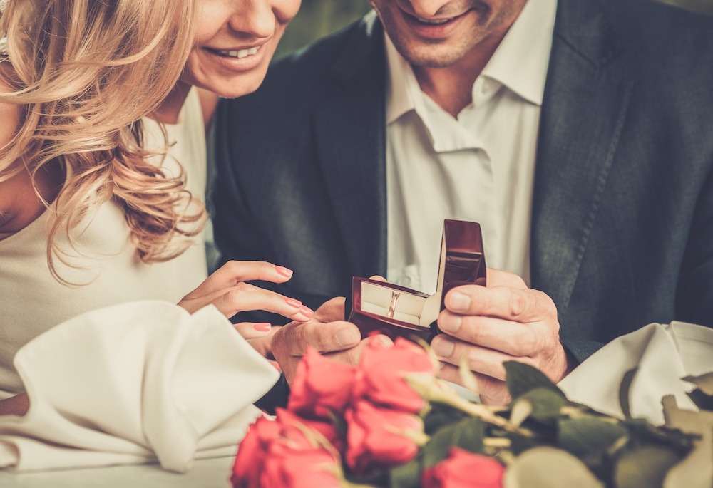 Man proposing to wife with engagement ring