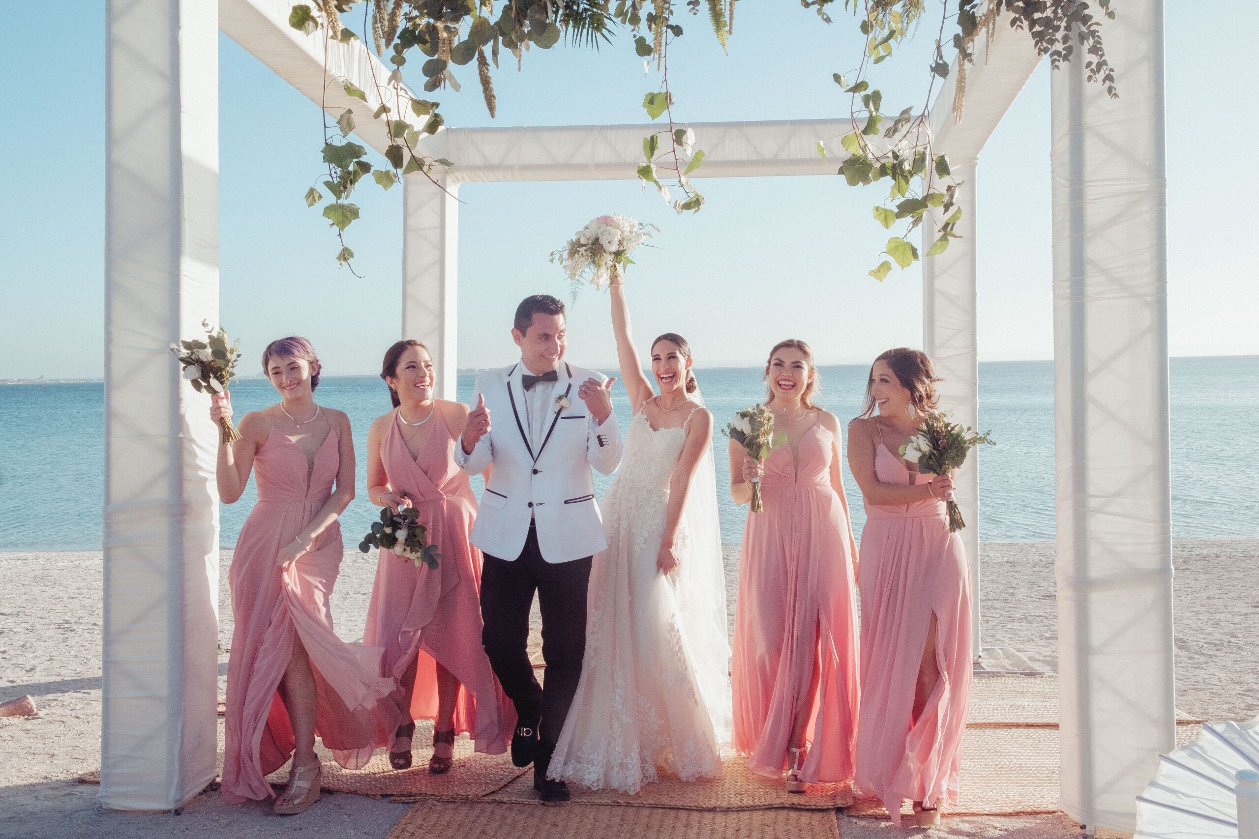 A group of bridesmaids with the bride and groom