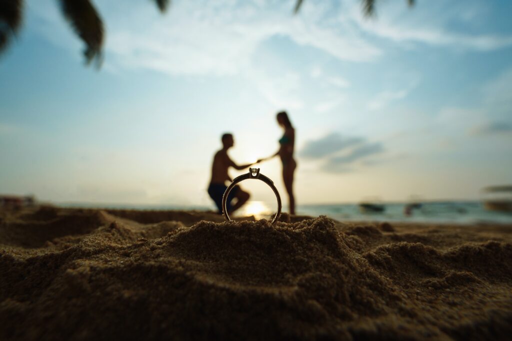 a man proposing to a woman at a beach